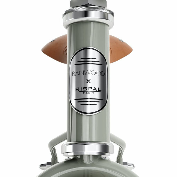 Close up of the brand seal from the sage coloured Banwood Icon Balance Bike